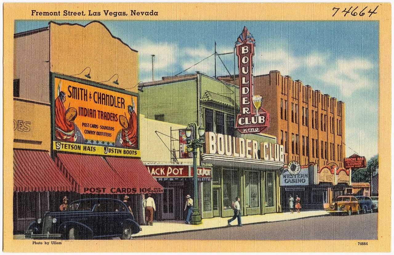 A historical colour postcard of Fremont Street and its casino signs in downtown Las Vegas